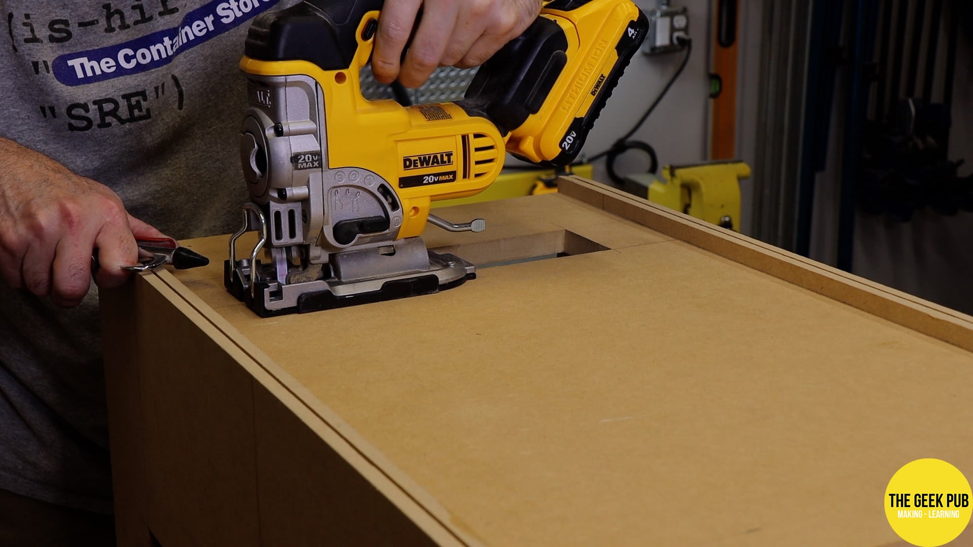 Using the jigsaw to cut an access port for the control panels.